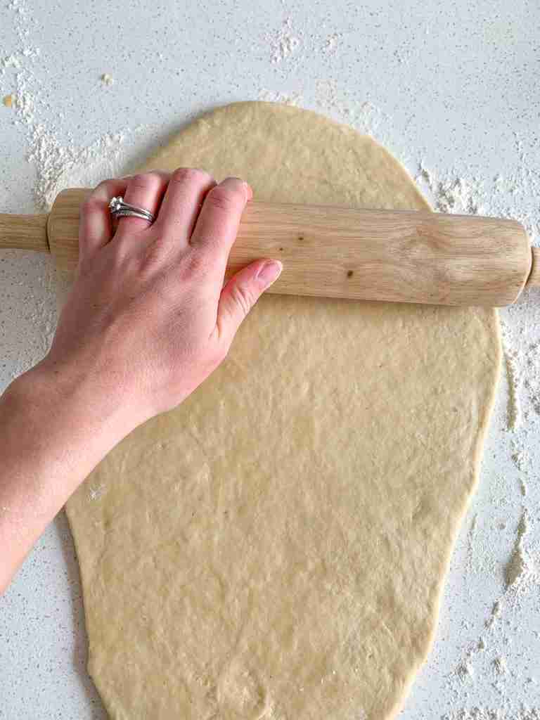 process of rolling out sourdough crescent rolls