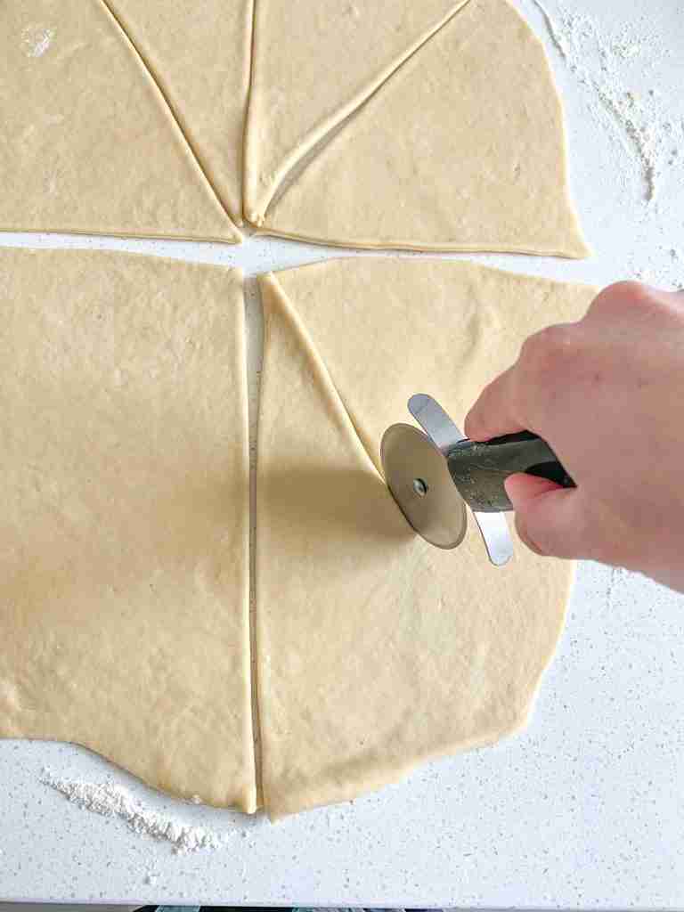diving sourdough crescent roll dough into sections