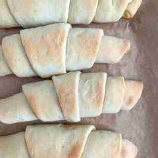 freshly baked flaky sourdough crescent rolls