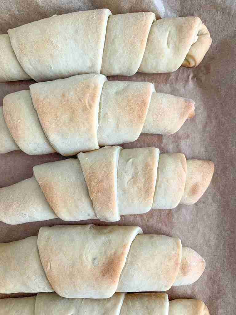 freshly baked flaky sourdough crescent rolls