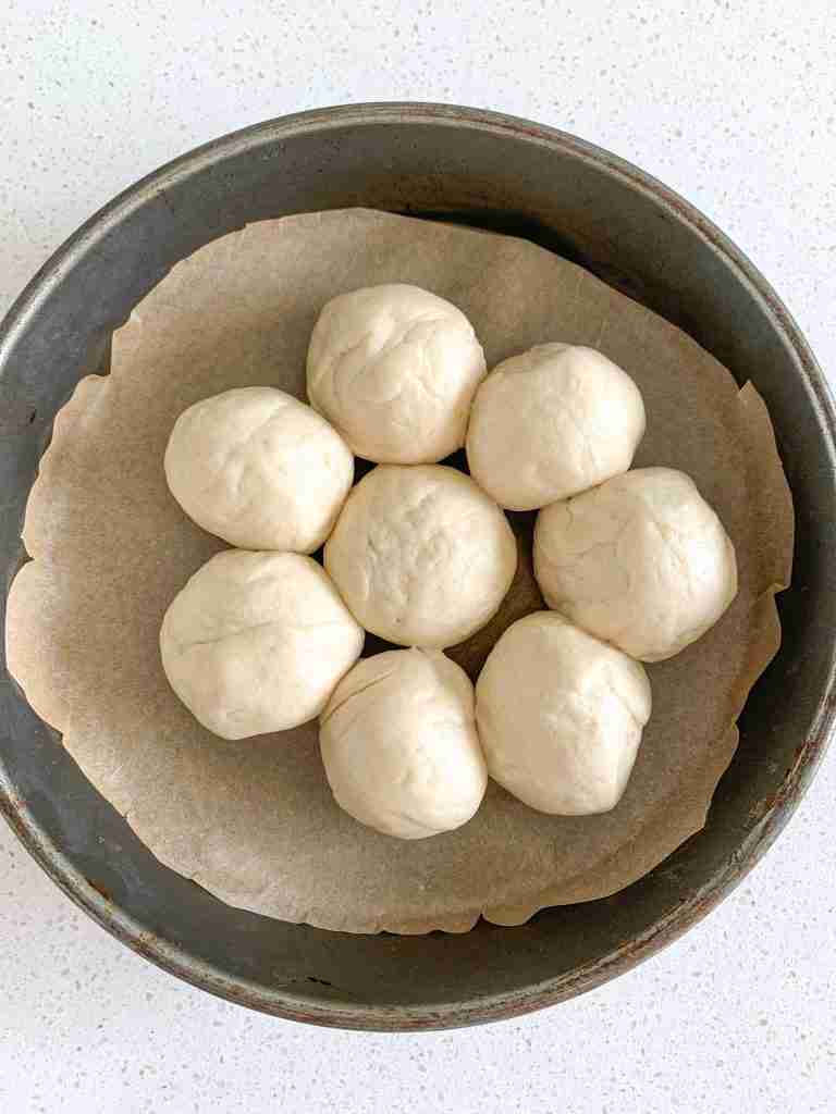 sourdough honey butter roll dough shaped and placed in a pan