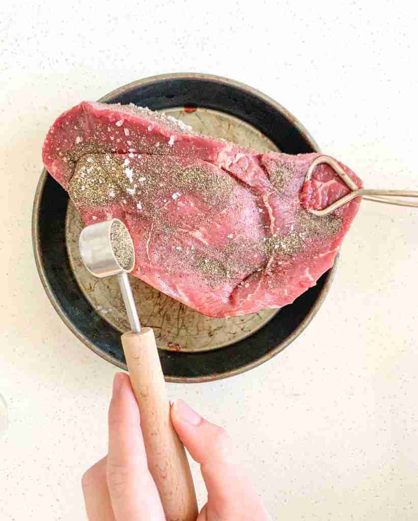 beef roast getting seasoned for slow cooker french dip sandwiches