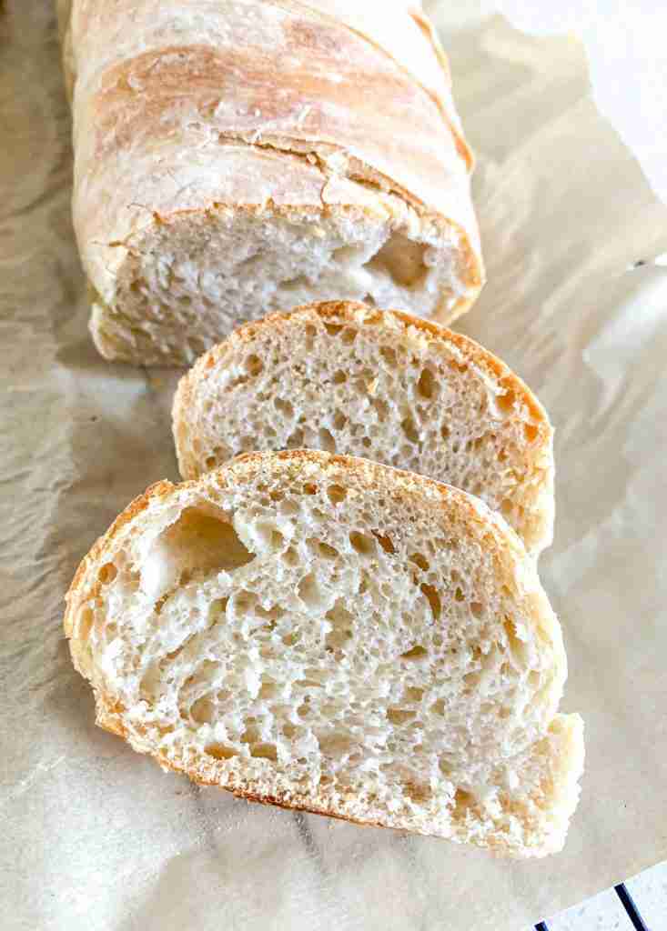 freshly baked sourdough french bread with a few slices off