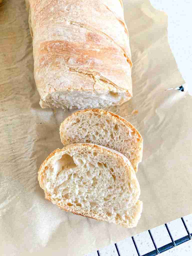 freshly baked sourdough french bread with a few slices off