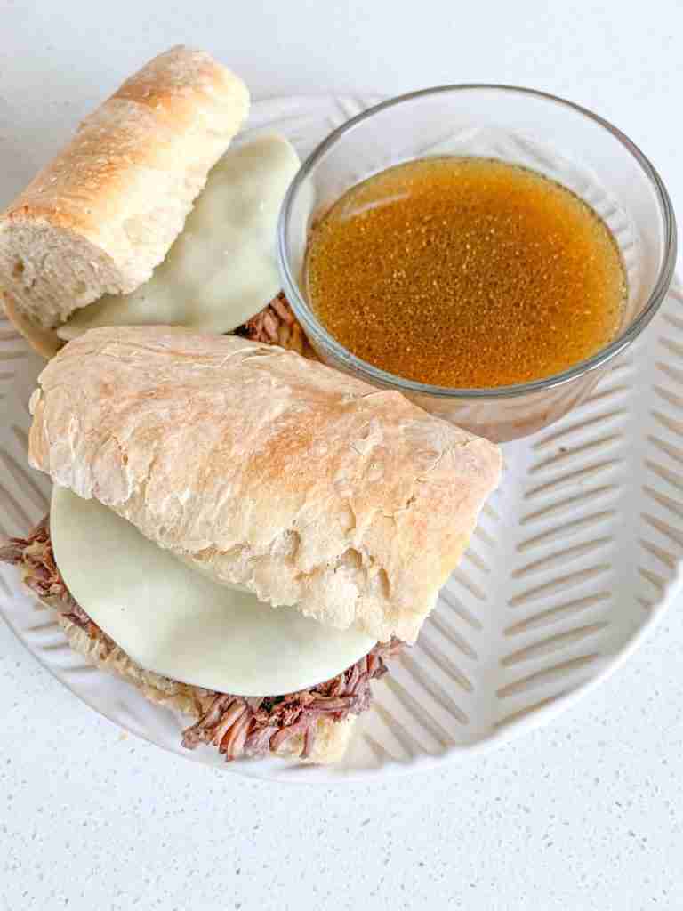 freshly made slow cooker french dip sandwiches with au jus on the side