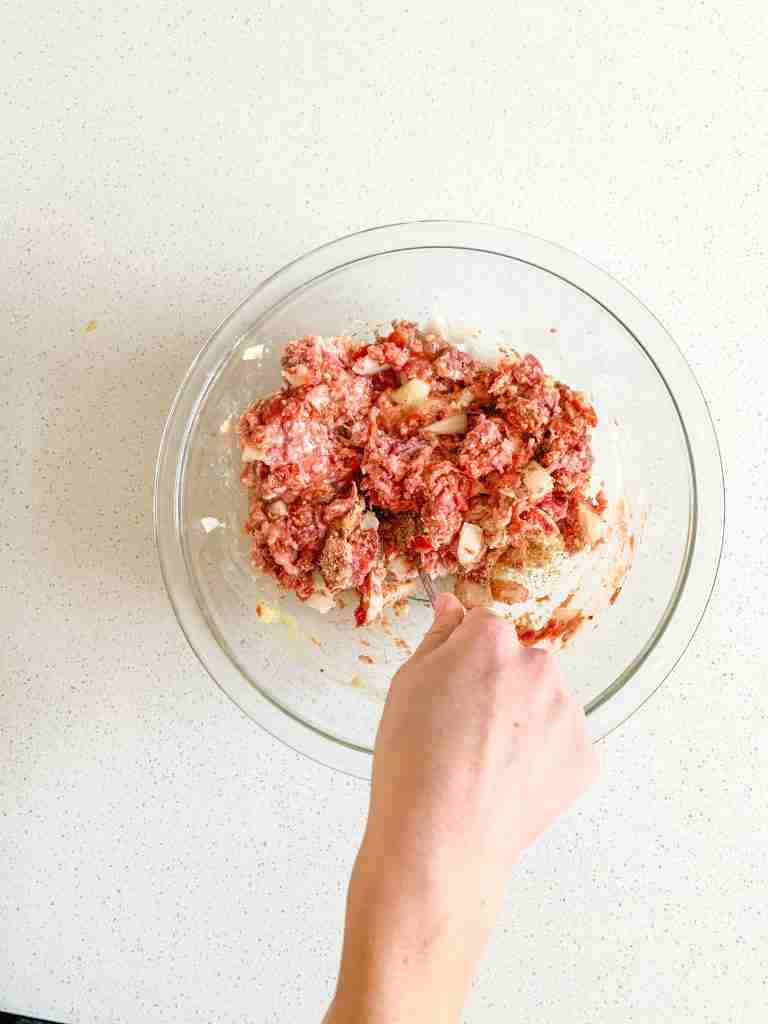 mixing mini meatloaf ingredients in a bowl