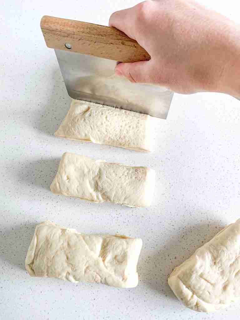 dividing steakhouse roll dough into 7 peices