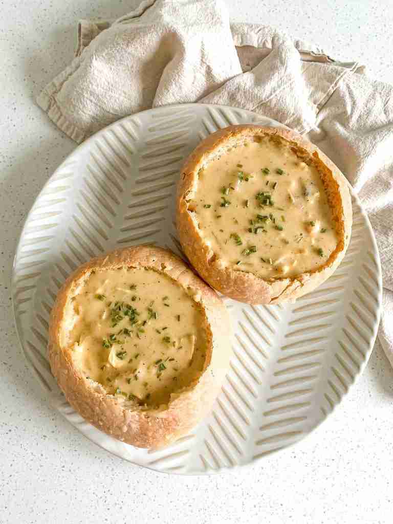 freshly baked sourdough bread bowls with soup in them