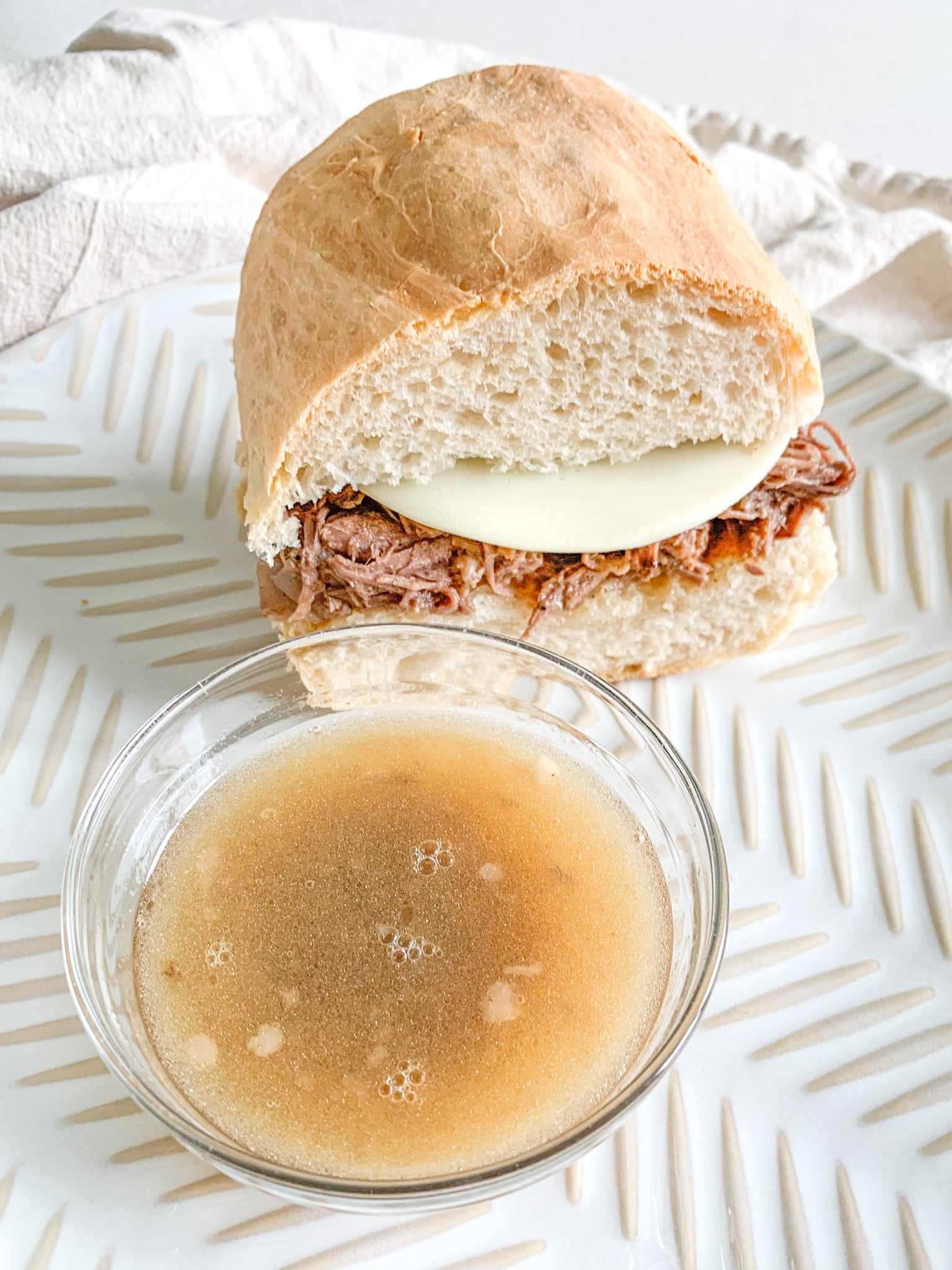 freshly cooked slow cooker french dip sandwich