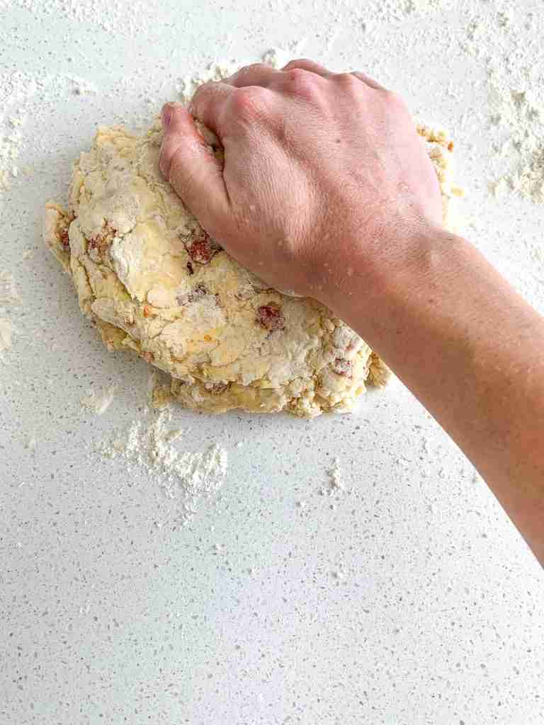 hand creating layers in the biscuit dough
