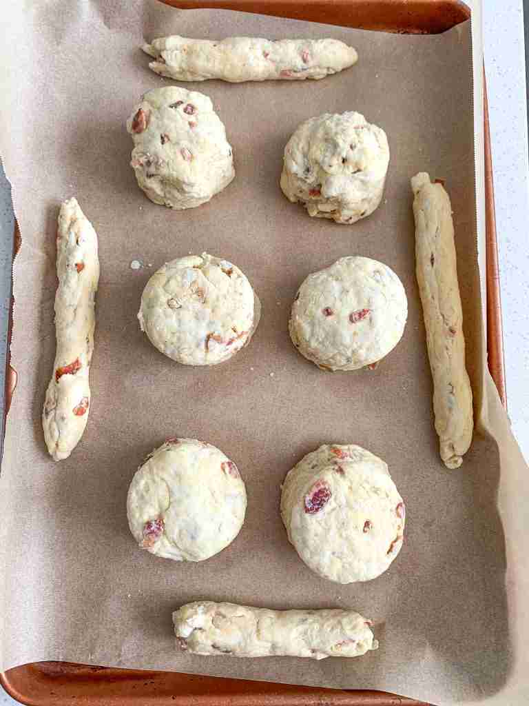 maple bacon biscuits cut out on a sheet pan ready to be baked