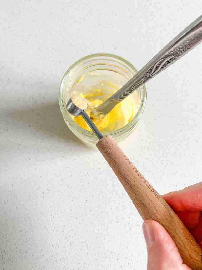 mixing together butter and garlic powder to make texas toast