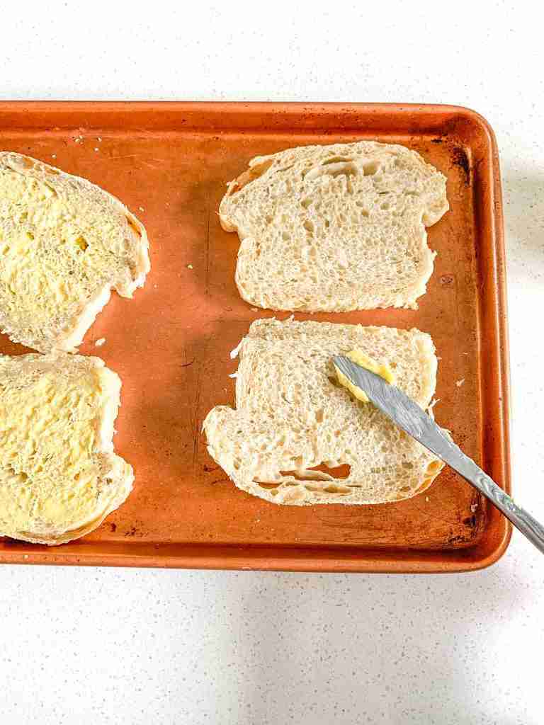 buttering sourdough bread for texas toast