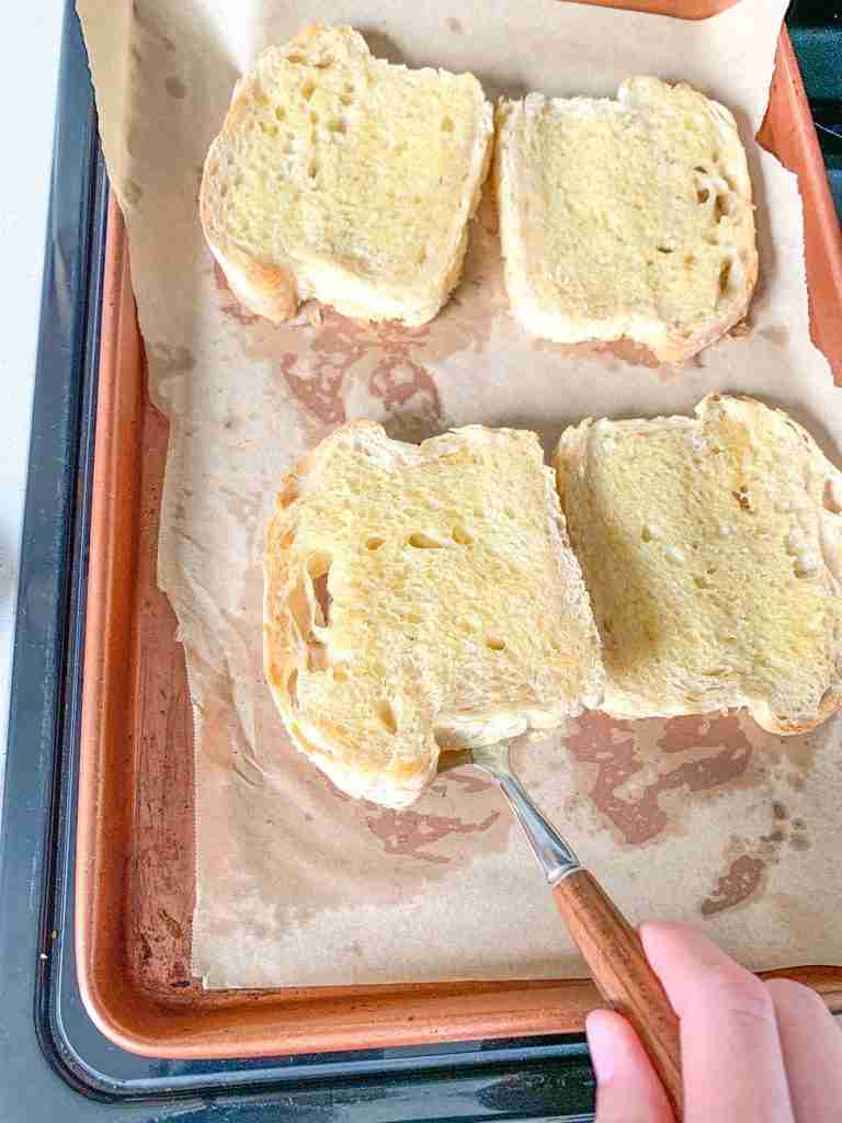 flipping sourdough texas toast over to bake the other side
