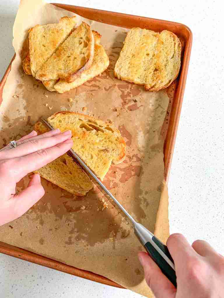 slicing baked sourdough texas toast in half
