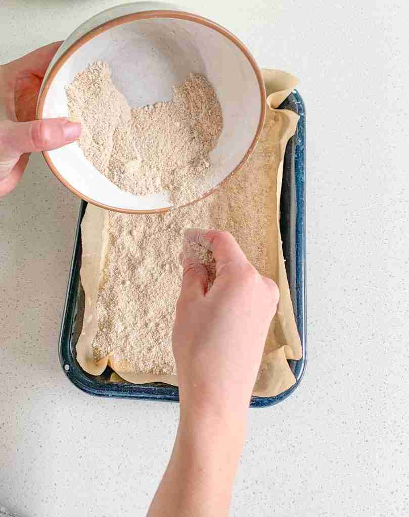 adding the cinnamon layer on top of the first layer of sourdough coffee cake batter