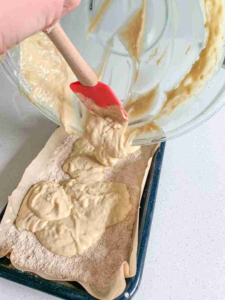 adding the second layer of sourdough coffee cake batter to the pan