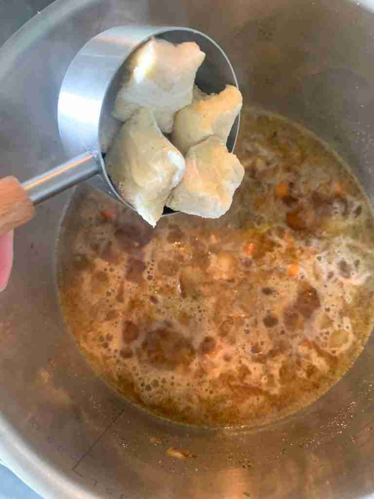 adding gnocchi to the pan for chicken gnocchi soup