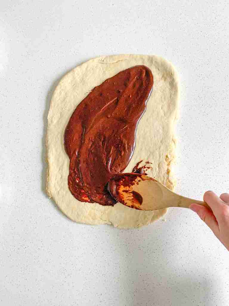 sourdough babka dough getting spread with chocolate filling