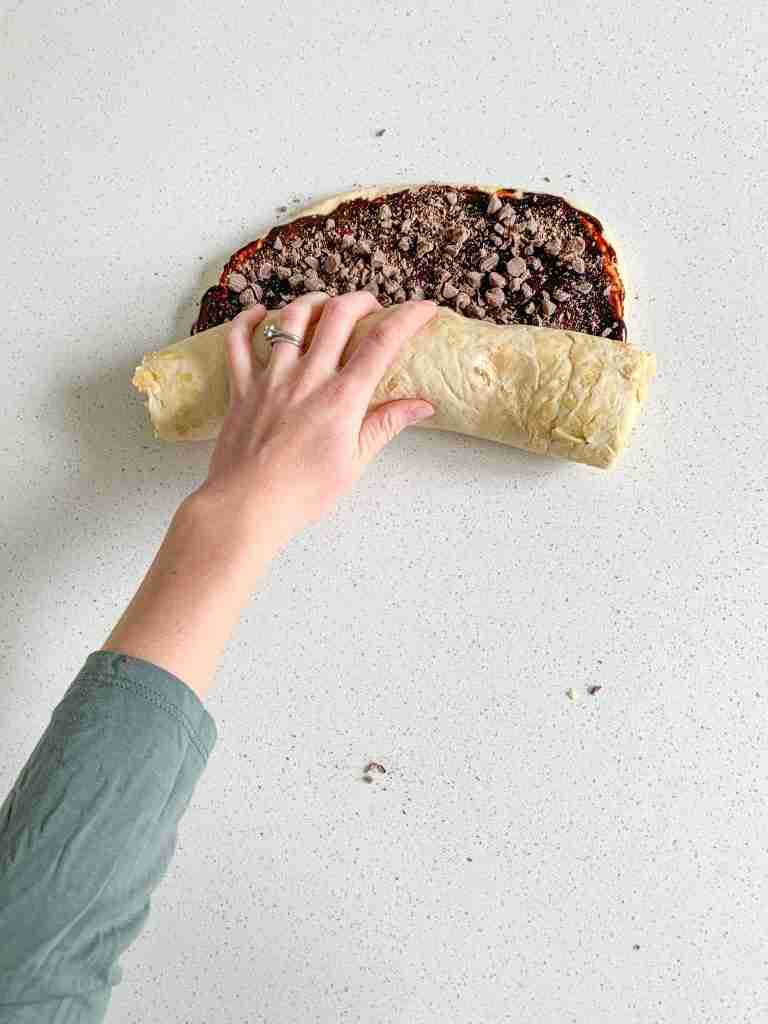 sourdough babka dough getting rolled up