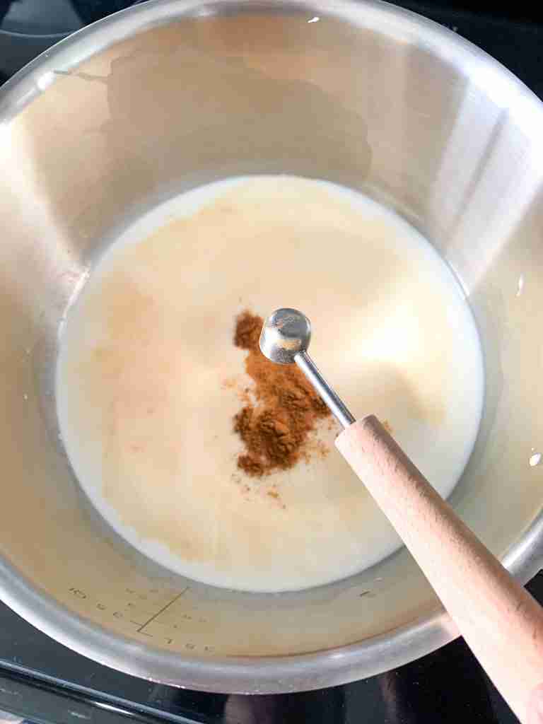 adding spices to the pan of milk for spiced hot chocolate