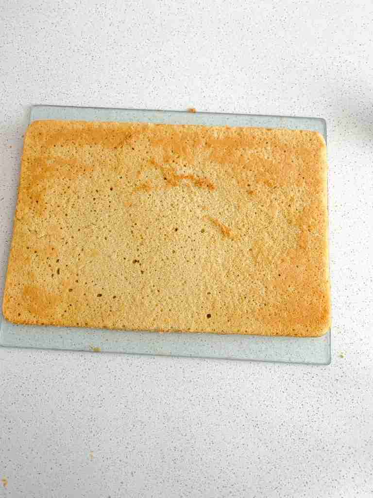 freshly baked sourdough cake flipped upside down on a cutting board