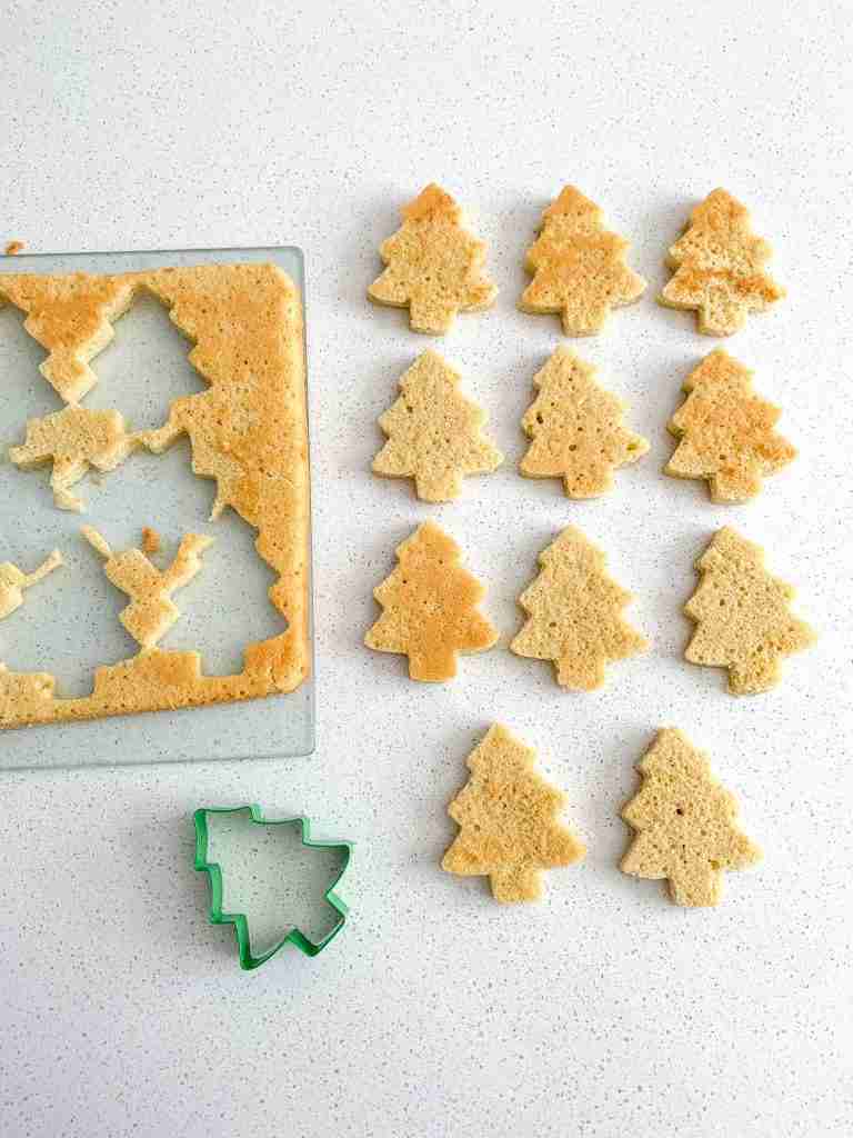 cutting out cake with a tree cutter for sourdough little debbie christmas tree cakes