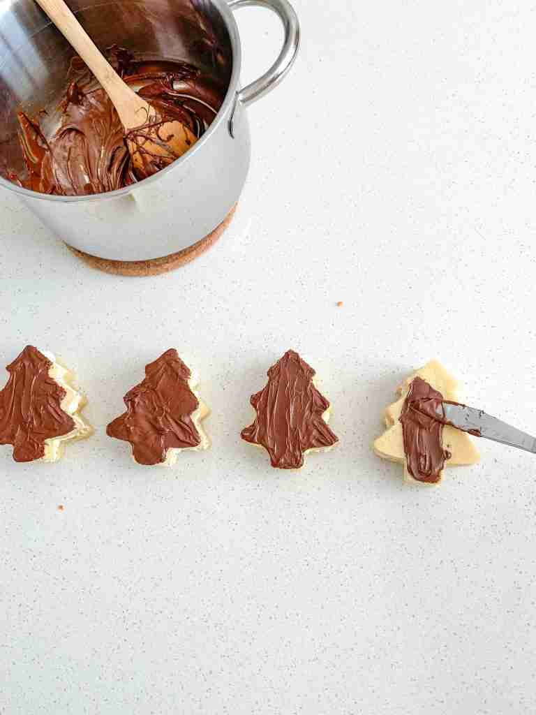 coating the sourdough little debbie christmas tree cakes with chocolate