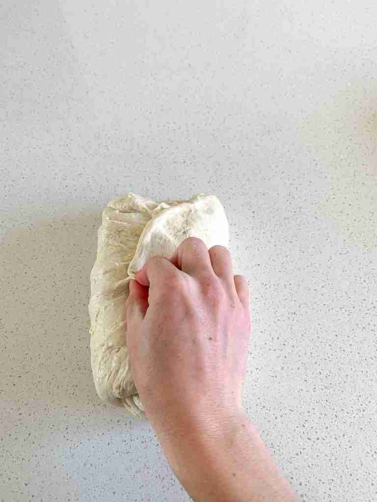 shaping artisan sourdough loaf dough