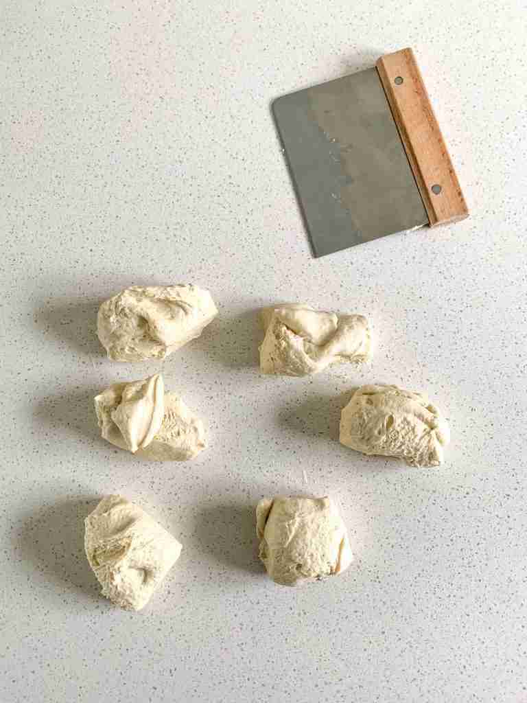 cutting sourdough garlic knot dough into peices