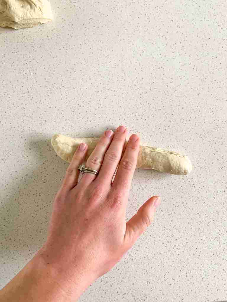 sourdough garlic knot dough getting rolled