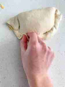 sealing calzone dough before baking