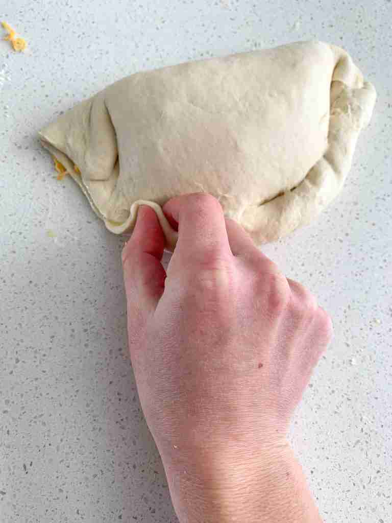sealing calzone dough before baking