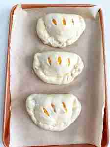 calzones filled and shaped ready for baking