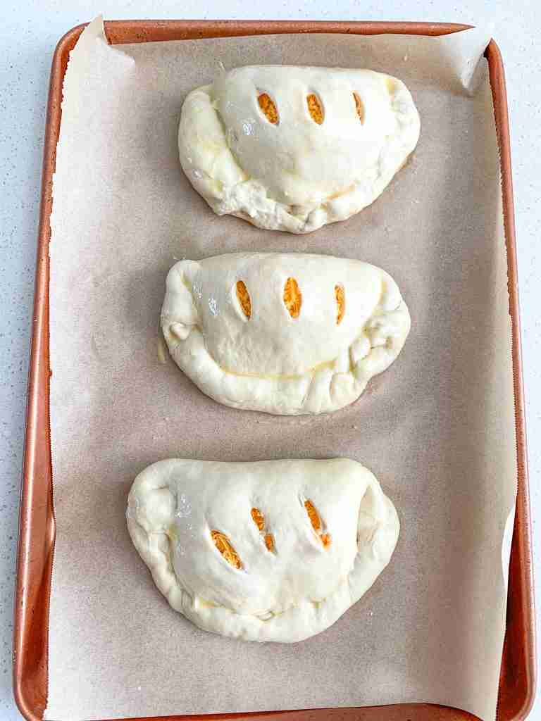 calzones filled and shaped ready for baking