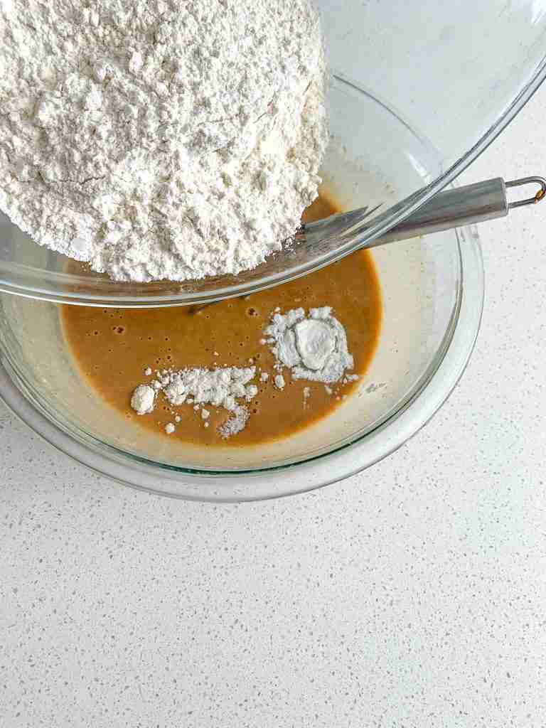 adding in flour to sourdough peanut butter chocolate chip muffin batter