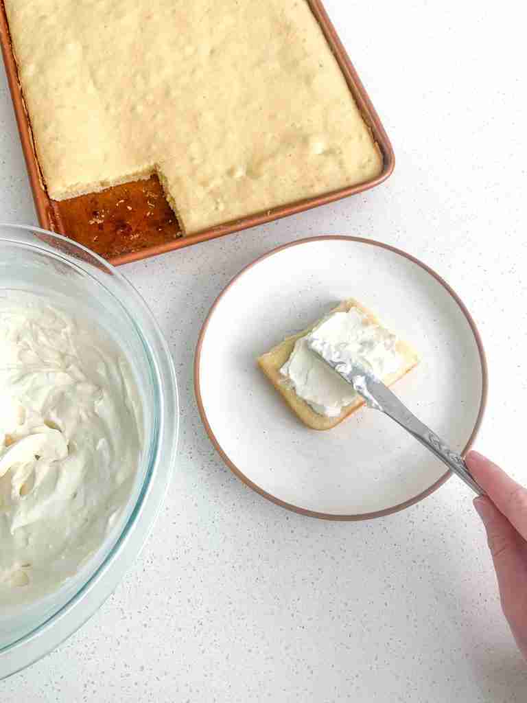 freshly baked sourdough vanilla cake with a slice frosted