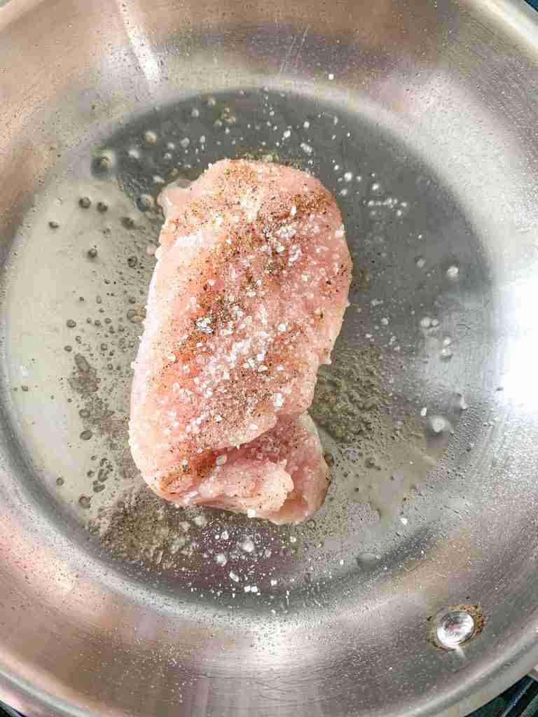 raw chicken getting cooked for alabama white bbq chicken bacon pizza
