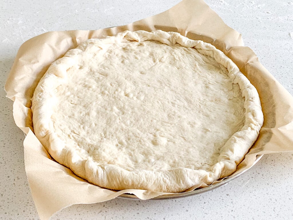 sourdough pizza crust shaped and ready to pre-bake
