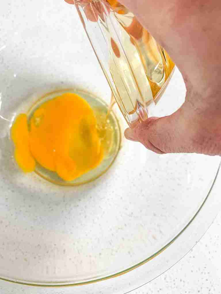 adding ingredients in a bowl to make sourdough buttermilk pancakes