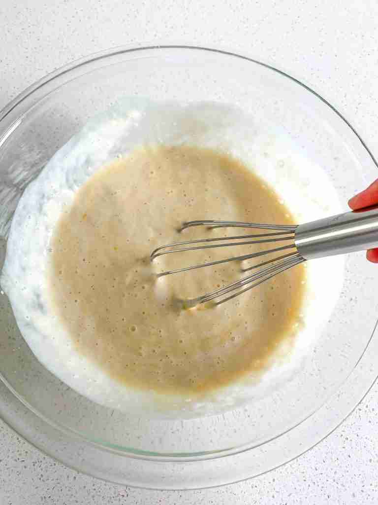 whisking wet ingredients together for sourdough buttermilk pancakes