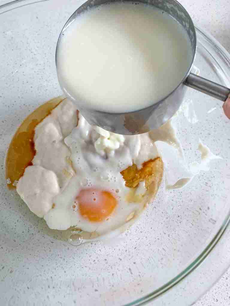 adding wet ingredients in a bowl for sourdough crepes