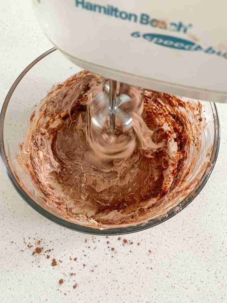 electric mixer beating ingredients for crepe filling