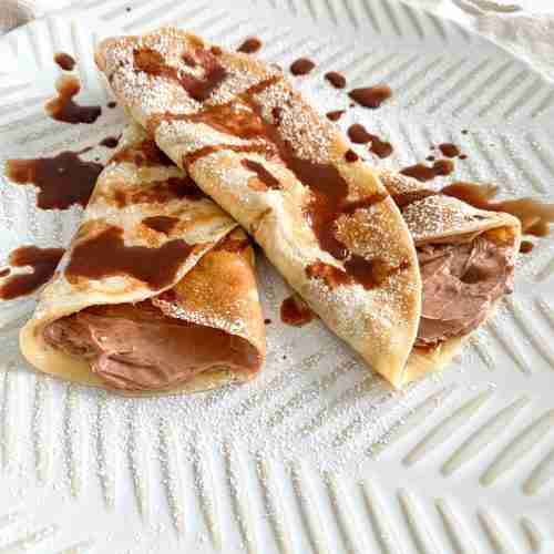 freshly made and filled sourdough crepes drizzled with chocolate syrup