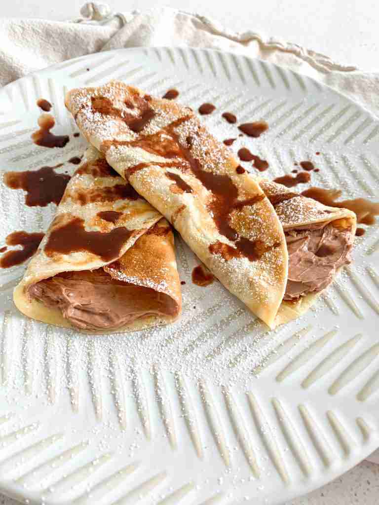 freshly made and filled sourdough crepes drizzled with chocolate syrup