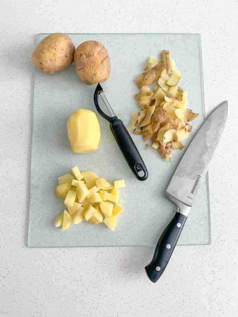 potatoes getting peeled and diced for bacon breakfast burritos
