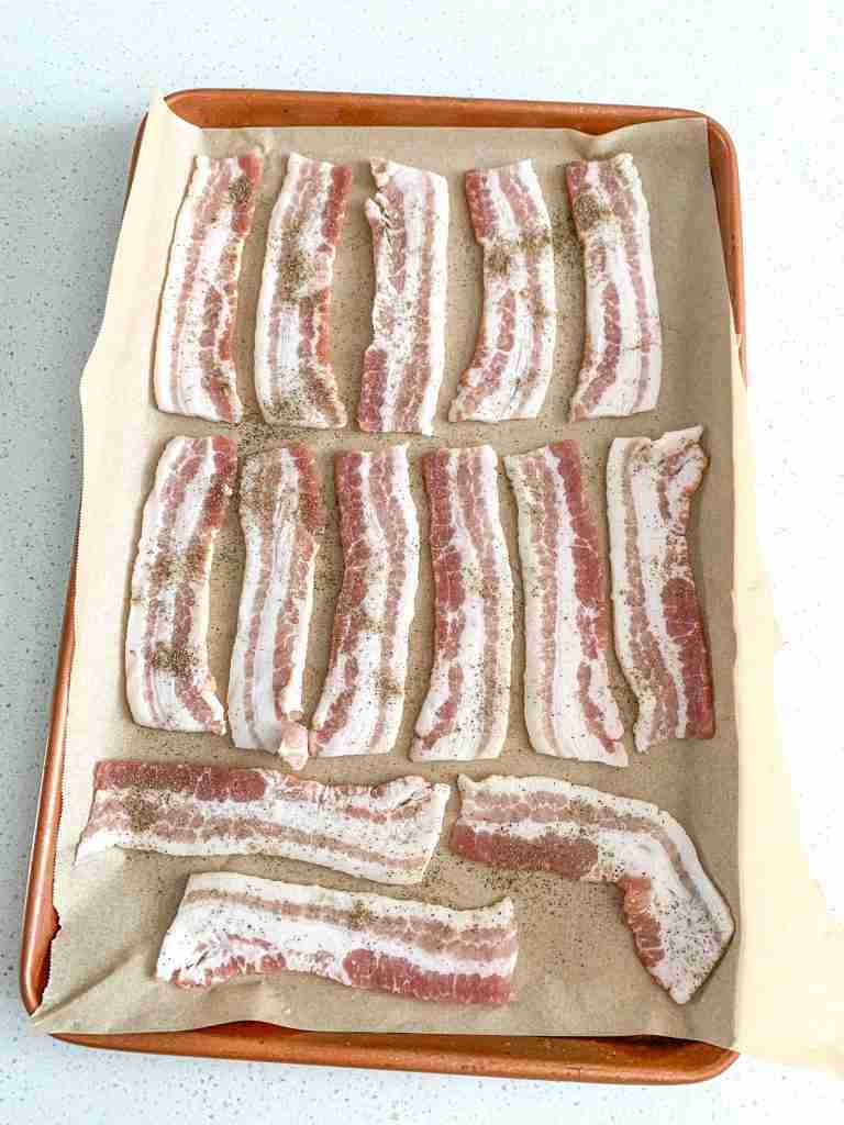 bacon on a sheet pan ready to be baked for bacon breakfast burritos