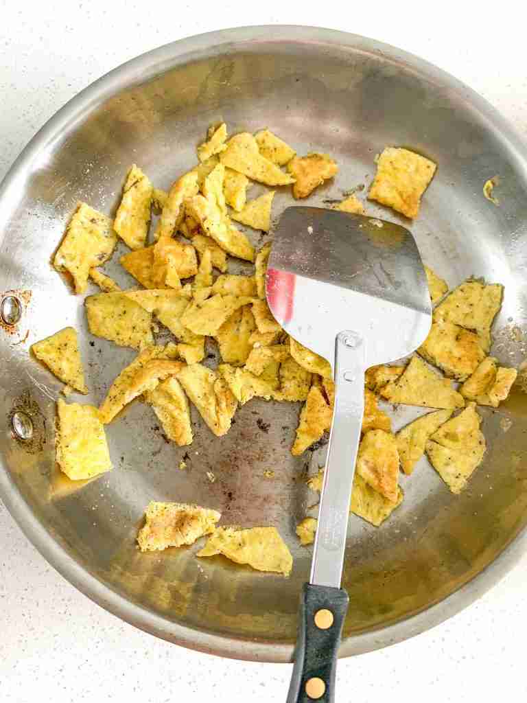 eggs being cooked for bacon breakfast burrito