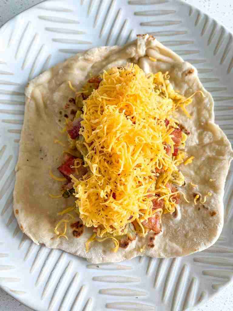 bacon breakfast burrito ingredients on the shell