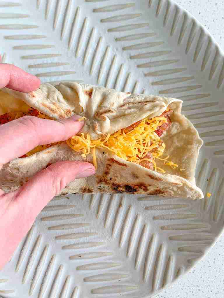 bacon breakfast burrito getting assembled